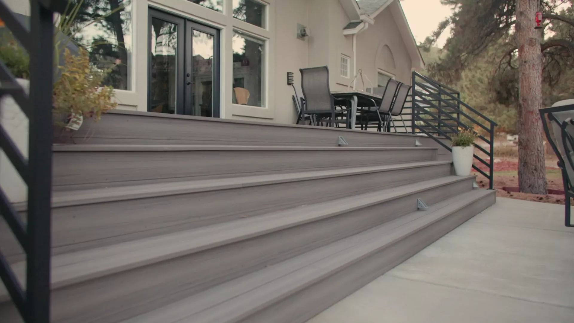 A Stoddard deck and railing running the full width of the house