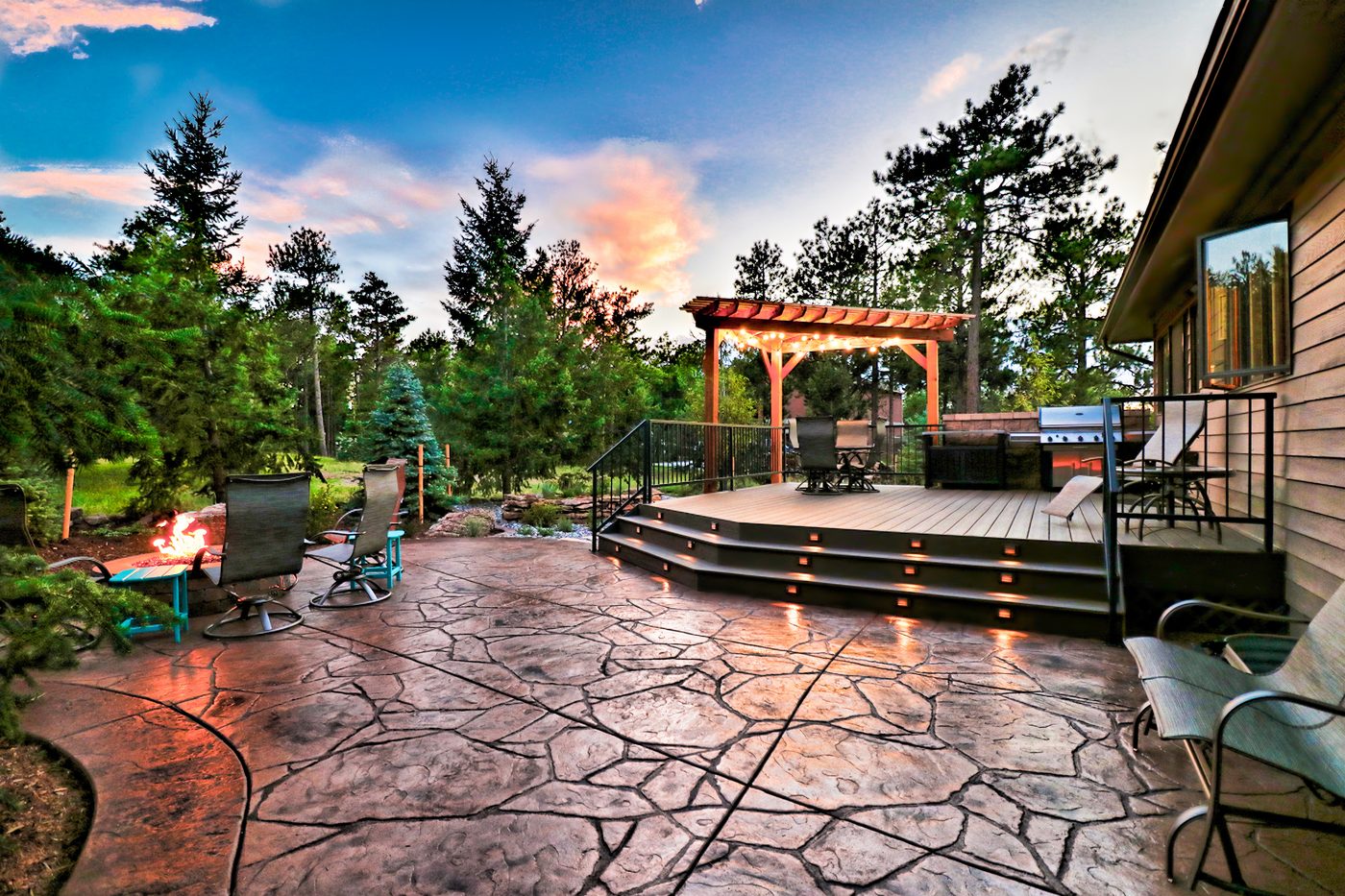 A pergola and deck at sunset